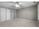 Neutral bedroom with a closet, ceiling fan, and doorway, providing ample space and natural light at 6610 Maynard Farm Rd, Chapel Hill, NC 27516