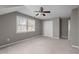 Bedroom features plush carpet, a ceiling fan, dormer windows, and closet space for comfortable living at 6610 Maynard Farm Rd, Chapel Hill, NC 27516