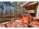 Large, stained deck featuring wood railing and ceiling fan, ideal for outdoor entertaining and relaxation at 6610 Maynard Farm Rd, Chapel Hill, NC 27516