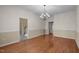 Open dining room featuring hardwood floors and a chandelier at 6610 Maynard Farm Rd, Chapel Hill, NC 27516