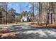 Spacious lot with a long gravel driveway and plenty of trees offers privacy and potential at 6610 Maynard Farm Rd, Chapel Hill, NC 27516
