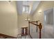 Two-story foyer with a chandelier and wood staircase leads to a cozy carpeted hallway at 6610 Maynard Farm Rd, Chapel Hill, NC 27516