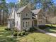 Beautiful home with manicured landscaping, lush greenery, and a blend of stone and siding exterior at 6610 Maynard Farm Rd, Chapel Hill, NC 27516