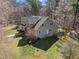 Beautiful home boasts a well-manicured lawn, lush greenery, and a serene setting surrounded by mature trees at 6610 Maynard Farm Rd, Chapel Hill, NC 27516