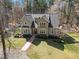 Spacious home boasts lush landscaping, a stone and siding exterior, complemented by mature trees and a well-manicured lawn at 6610 Maynard Farm Rd, Chapel Hill, NC 27516