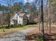 Charming home with a well-maintained lawn, mature trees, and a gravel driveway nestled in a serene wooded setting at 6610 Maynard Farm Rd, Chapel Hill, NC 27516