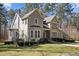 The beautiful home with stone and siding accents provides timeless charm and complemented by the surrounding landscape at 6610 Maynard Farm Rd, Chapel Hill, NC 27516