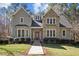 Charming two-story home with stone and siding exterior, manicured lawn, and inviting entryway at 6610 Maynard Farm Rd, Chapel Hill, NC 27516