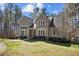 Attractive home with a stone accent, well-maintained lawn, and mature trees offers a serene and picturesque setting at 6610 Maynard Farm Rd, Chapel Hill, NC 27516