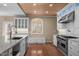 Kitchen boasts stainless steel appliances, granite countertops, and a center island with seating at 6610 Maynard Farm Rd, Chapel Hill, NC 27516