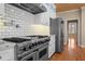 Gourmet kitchen boasts stainless steel appliances, granite countertops, and subway tile backsplash at 6610 Maynard Farm Rd, Chapel Hill, NC 27516