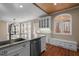 Bright kitchen with granite countertops, white cabinets, stainless steel appliances, and a built-in bench at 6610 Maynard Farm Rd, Chapel Hill, NC 27516