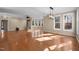 Bright living room with wood floors, a fireplace, and large windows overlooking wooded landscape at 6610 Maynard Farm Rd, Chapel Hill, NC 27516
