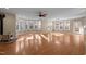Bright and spacious living room with a wood-burning stove, hardwood floors, and large windows at 6610 Maynard Farm Rd, Chapel Hill, NC 27516