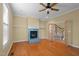 Spacious living room with a fireplace, hardwood floors, and natural light at 6610 Maynard Farm Rd, Chapel Hill, NC 27516