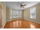 Bright living room featuring hardwood floors, a ceiling fan, and bay windows at 6610 Maynard Farm Rd, Chapel Hill, NC 27516