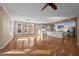 Open concept living space with hardwood floors transitions to a kitchen with a center island at 6610 Maynard Farm Rd, Chapel Hill, NC 27516
