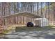 Covered outdoor storage with greenhouse and adjacent wooded area, perfect for hobbies or extra parking at 6610 Maynard Farm Rd, Chapel Hill, NC 27516