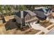 An aerial view shows a brick facade home with a well-manicured lawn and attached two-car garage at 705 Prince Dr, Holly Springs, NC 27540