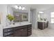 Bathroom featuring a double vanity, a shower, tile flooring, and large mirror at 705 Prince Dr, Holly Springs, NC 27540