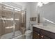 Bathroom featuring a glass shower, tile and a dark wood vanity with sink and a mirror at 705 Prince Dr, Holly Springs, NC 27540