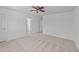 Spacious bedroom featuring neutral carpeting and ceiling fan, offering a serene retreat at 705 Prince Dr, Holly Springs, NC 27540