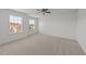 Spacious, light-filled bedroom with neutral carpet, ceiling fan, and double windows providing ample natural light at 705 Prince Dr, Holly Springs, NC 27540