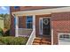 Charming front entrance with a decorative wreath and brick-lined porch, number 705 at 705 Prince Dr, Holly Springs, NC 27540