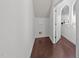 Hallway features hardwood floors, white walls, and white trim at 705 Prince Dr, Holly Springs, NC 27540