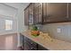Granite counter with under cabinet lighting, decorative ceramics and light backsplash at 705 Prince Dr, Holly Springs, NC 27540