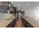 Well-equipped kitchen with dark wood cabinets, granite countertops, and stainless steel appliances at 705 Prince Dr, Holly Springs, NC 27540