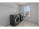 Modern laundry room with sleek appliances, a bright window, and ample space for convenience at 705 Prince Dr, Holly Springs, NC 27540