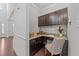 Compact office space featuring dark wood cabinets, granite countertops, and ample storage at 705 Prince Dr, Holly Springs, NC 27540
