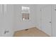 Compact storage space with tile flooring, a small window, and white door at 705 Prince Dr, Holly Springs, NC 27540