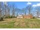 This spacious backyard features mature trees providing plenty of shade and greenery at 709 S Sellars Mill Rd, Burlington, NC 27217