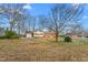 A wide shot of the backyard, showcasing the yard and exterior of the home at 709 S Sellars Mill Rd, Burlington, NC 27217