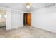 A bright bedroom with a ceiling fan, closet, and an adjacent bathroom for easy living at 709 S Sellars Mill Rd, Burlington, NC 27217