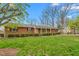 Classic brick home with mature landscaping, including manicured bushes and a green lawn at 709 S Sellars Mill Rd, Burlington, NC 27217