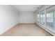 Bright living room with neutral carpet and large windows offering natural light at 709 S Sellars Mill Rd, Burlington, NC 27217