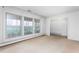 Bright living room with neutral carpet and large windows overlooking lush greenery at 709 S Sellars Mill Rd, Burlington, NC 27217