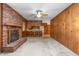 Spacious living room with brick fireplace and view into the eat-in kitchen with breakfast bar at 709 S Sellars Mill Rd, Burlington, NC 27217