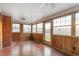 Bright sunroom features wood paneling, lots of windows and a ceiling fan at 709 S Sellars Mill Rd, Burlington, NC 27217