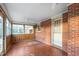 Charming sunroom features exposed brick, wood paneling and lots of windows at 709 S Sellars Mill Rd, Burlington, NC 27217