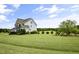 Spacious backyard with lush green grass, mature trees, and a well-maintained lawn at 71 Del Corso Ct, Clayton, NC 27527