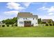 Spacious backyard with lush green grass and a covered deck for outdoor enjoyment at 71 Del Corso Ct, Clayton, NC 27527