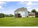 Expansive backyard features a well-maintained lawn, deck, and a play area at 71 Del Corso Ct, Clayton, NC 27527