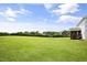 A sprawling backyard showcases its lush green grass, mature trees, and a serene setting at 71 Del Corso Ct, Clayton, NC 27527
