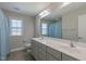 Bright bathroom features a double vanity with a large mirror and neutral paint at 71 Del Corso Ct, Clayton, NC 27527