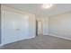 Neutral bedroom featuring plush carpeting, a ceiling light and closet with double doors at 71 Del Corso Ct, Clayton, NC 27527