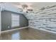 Attic bedroom features a ceiling fan, hardwood floors, and an accent wall at 71 Del Corso Ct, Clayton, NC 27527